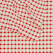 Close up view of Dove and Donkey wicker fringed tablecloth in cherry