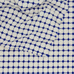 Close up view of Dove and Donkey wicker fringed tablecloth in cobalt