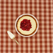Essential pie dish with cheesecake with gingham background