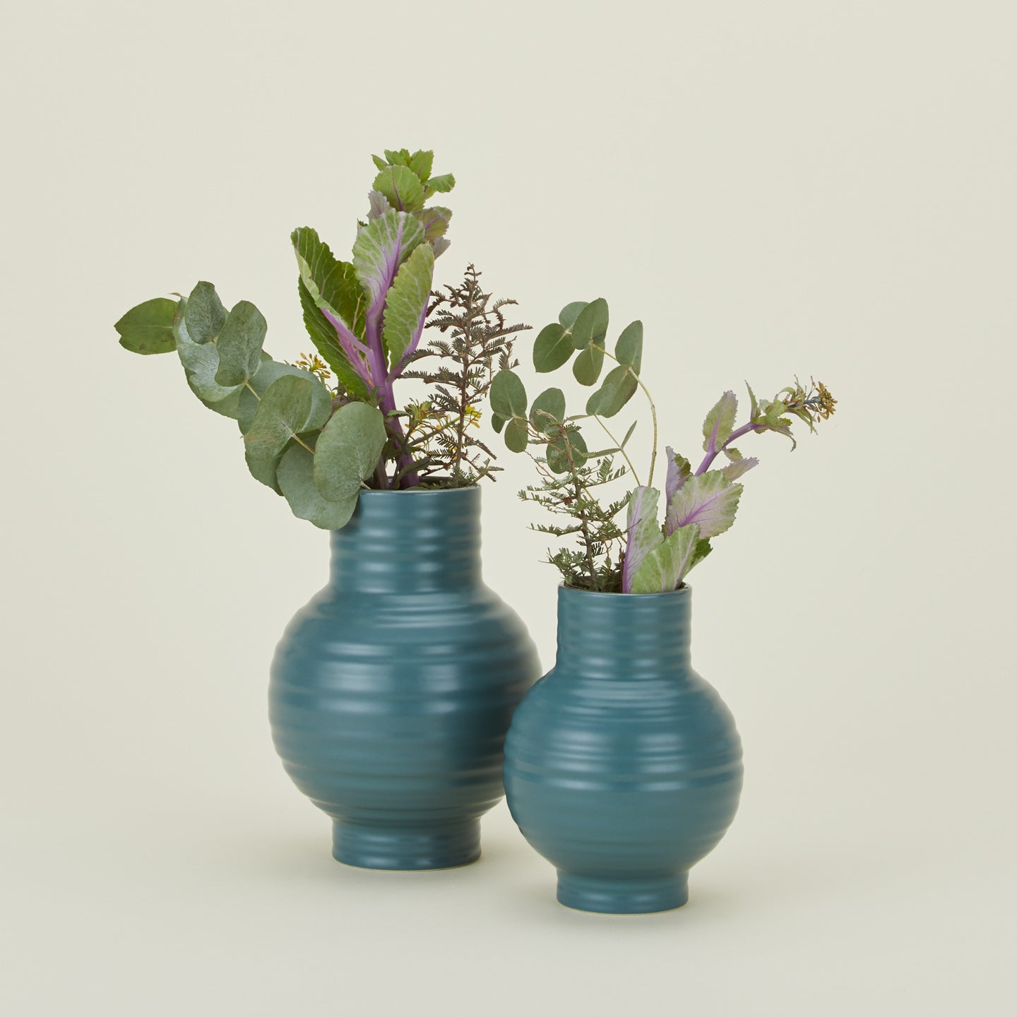 Large and small essential ceramic vase in peacock with flowers