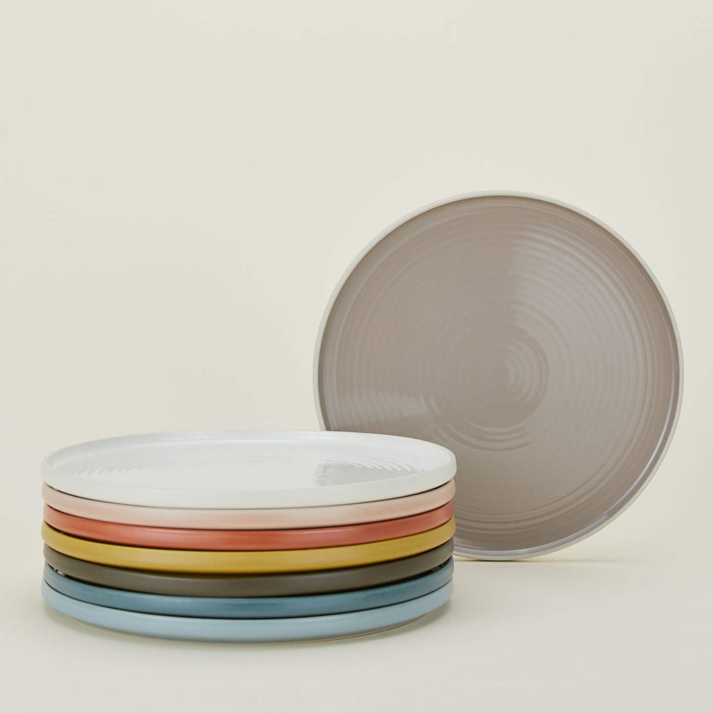 Stack of Essential Serving Platter in various colors.