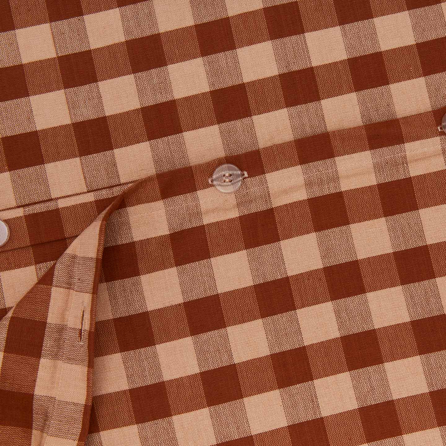 Close up view of essential gingham duvet in blush/terracotta