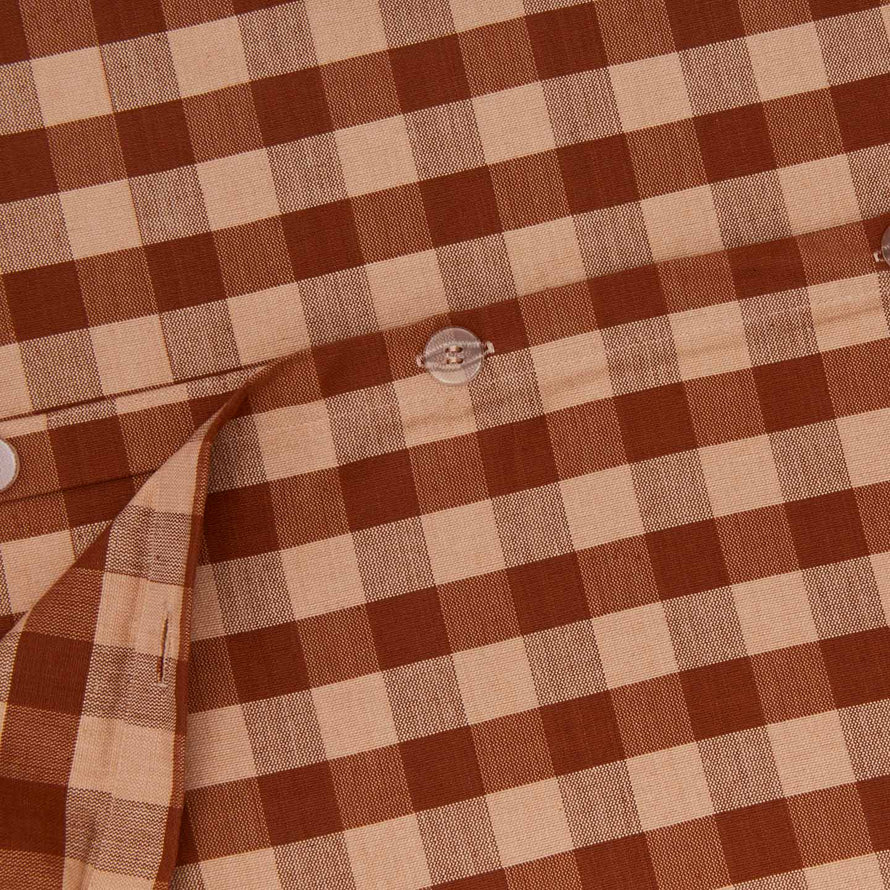 Close up view of essential gingham duvet in blush/terracotta