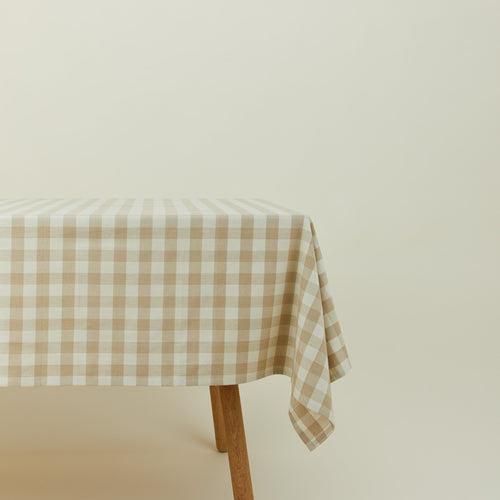 Essential Gingham tablecloth in ivory/flax on a table.