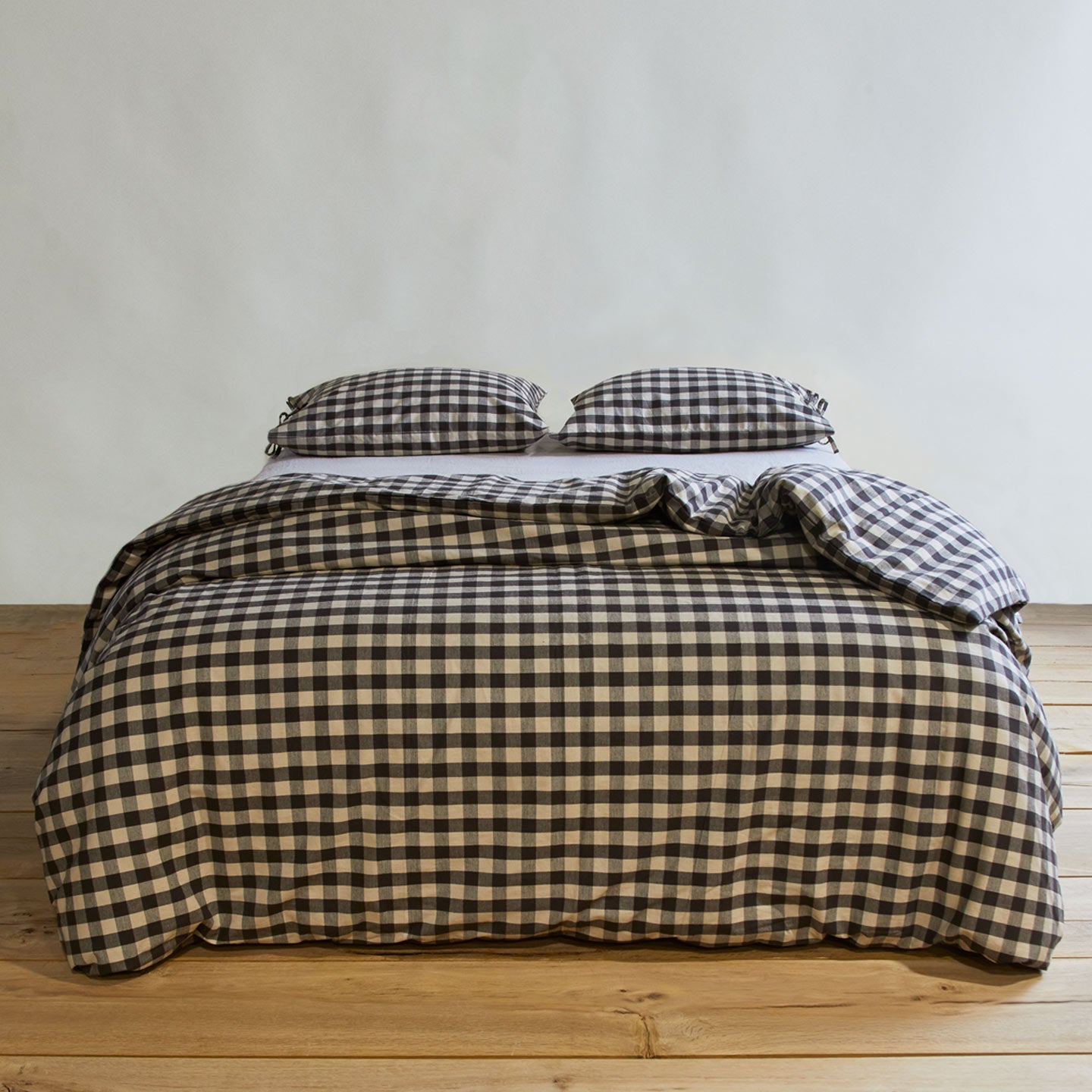 Essential Gingham Pillowcases, Set of 2 - Light Grey/Black on bed with matching duvet