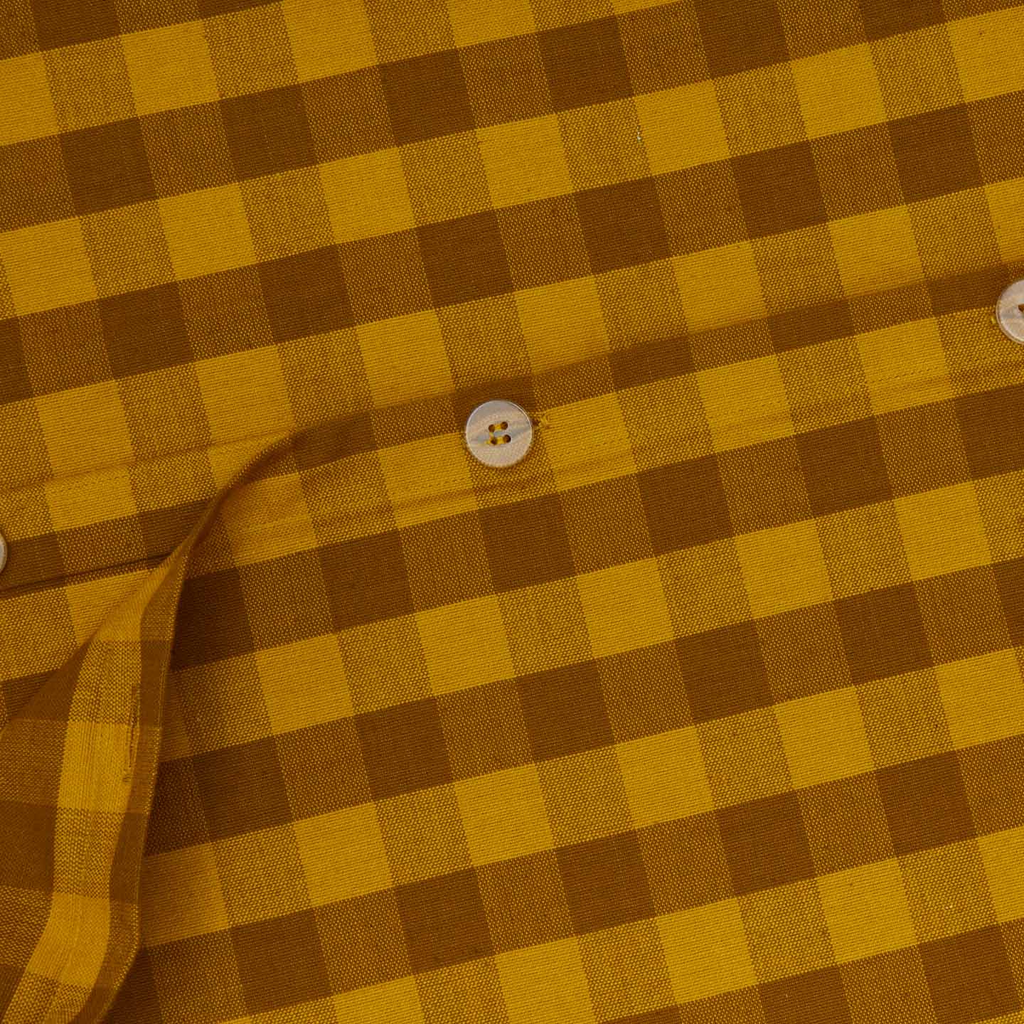 Close up view of essential gingham duvet cover in mustard/bronze