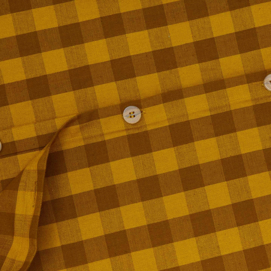 Close up view of essential gingham duvet cover in mustard/bronze