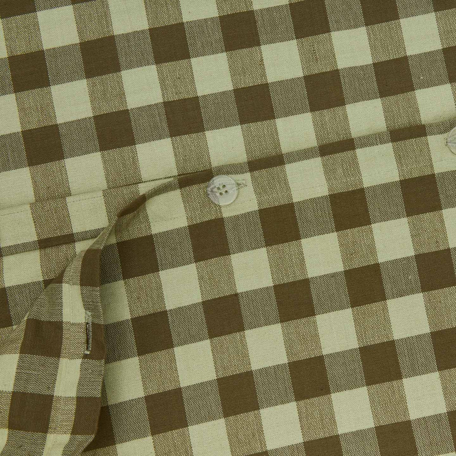 Close up view of essential gingham duvet cover in sage/olive