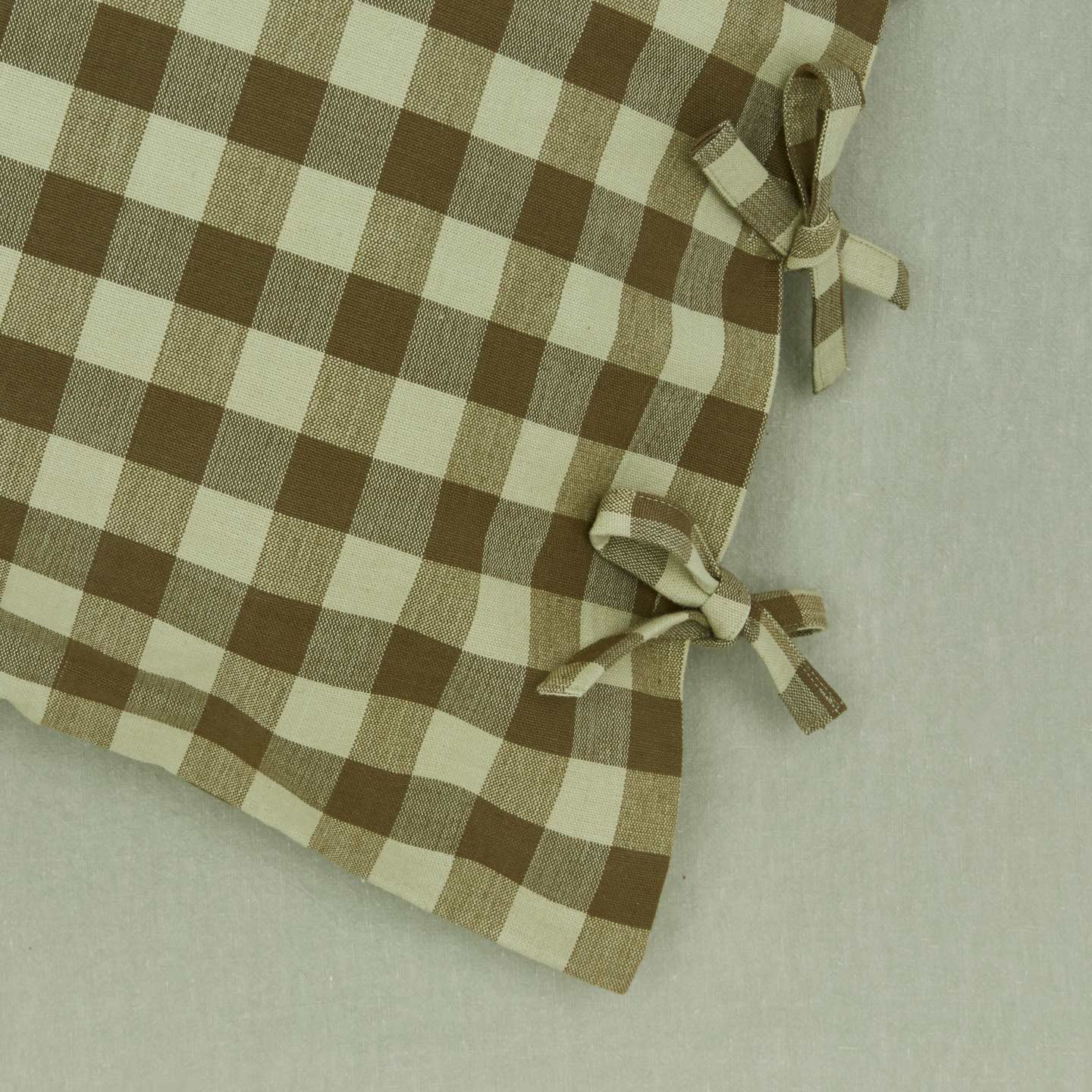 Close up view of essential gingham pillow case in olive/sage