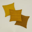 Essential gingham pillow in mustard / bronze with simple linen pillows in mustard and bronze