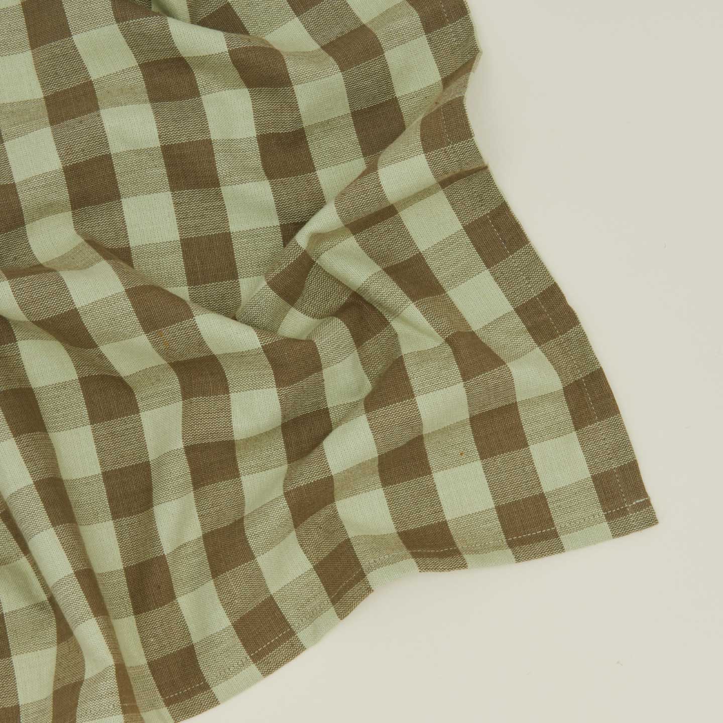 Close up view of Essential Gingham napkin in sage/olive