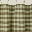 Gingham shower curtain in sage/olive on gold curtain hooks

