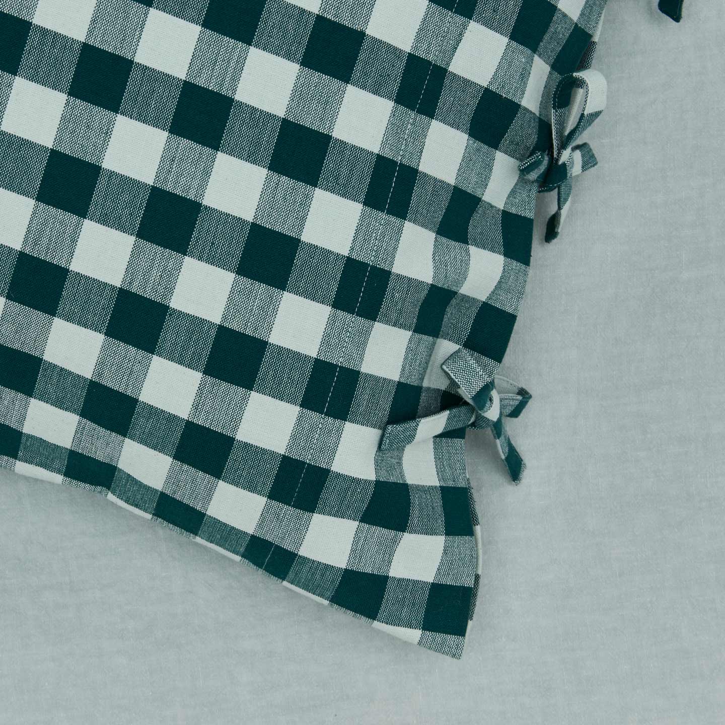 Close up view of essential gingham pillow case in sky/peacock