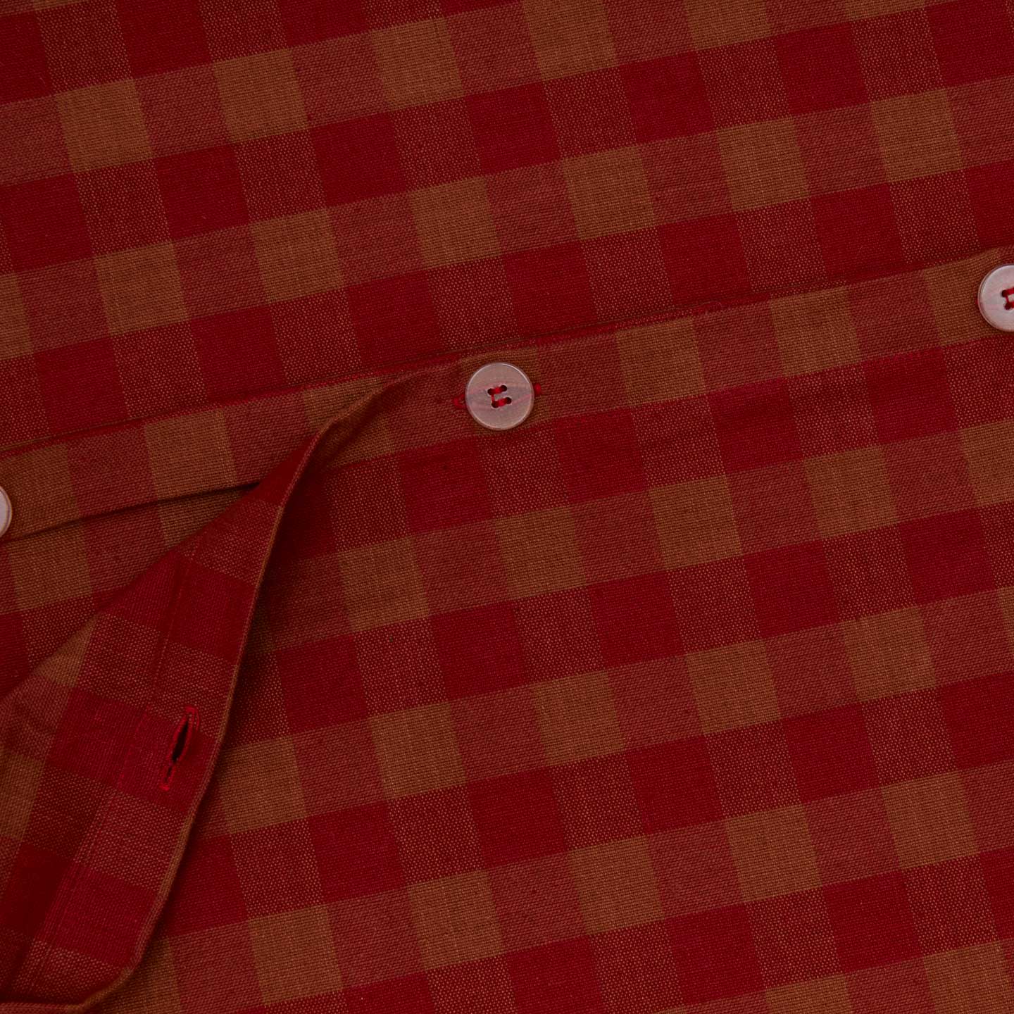 Close up view of essential gingham duvet cover in terracotta/red