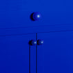 Large and small sphere knobs in klein blue on cabinet and drawer