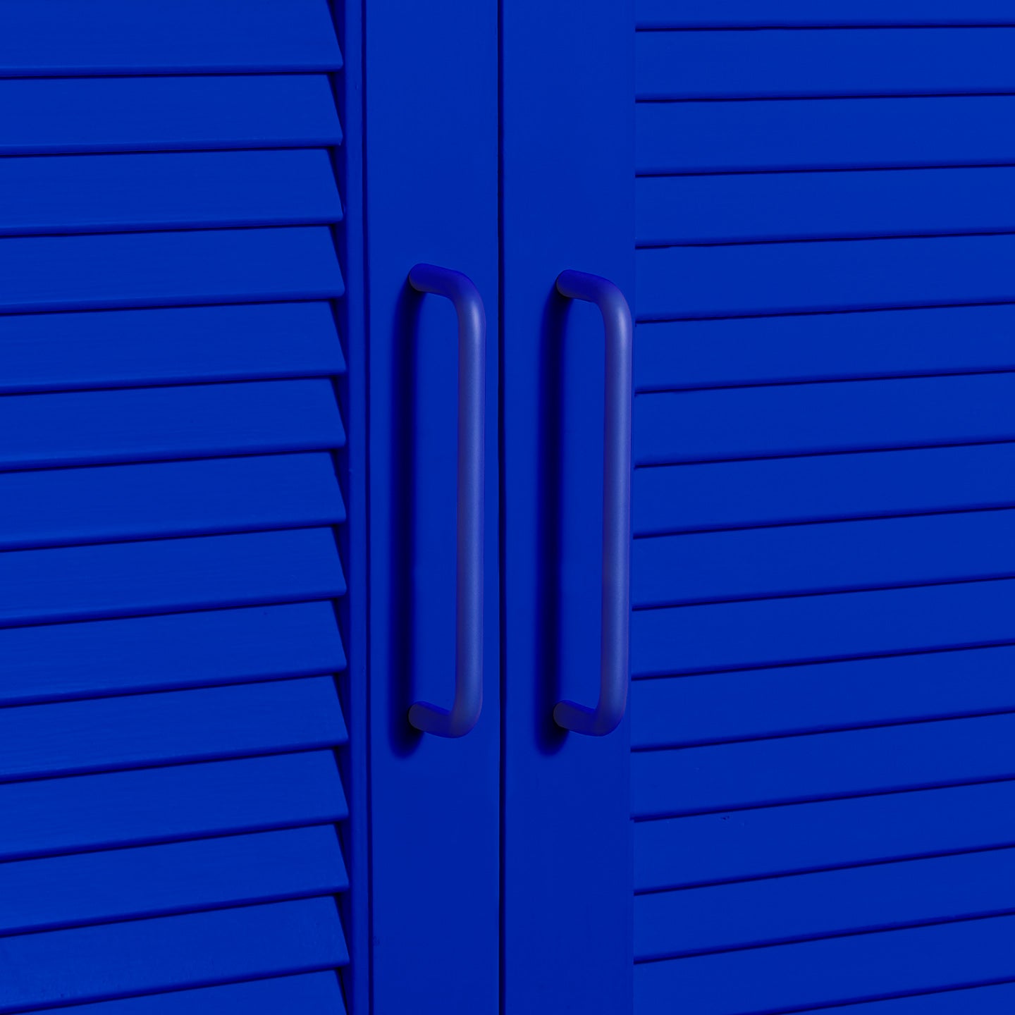 Large essential drawer pull in klein blue on cabinet