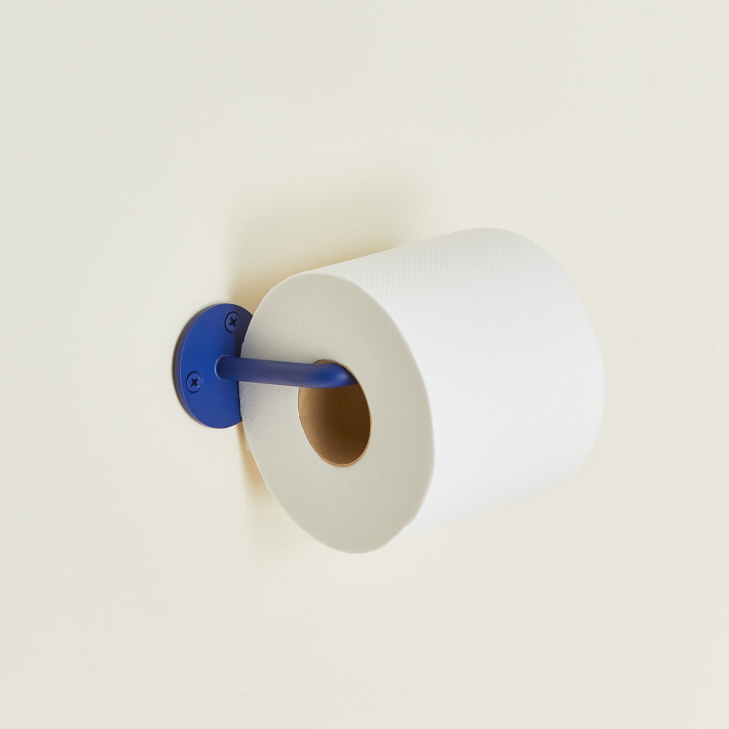 Essential toilet paper holder in klein blue with toilet paper roll