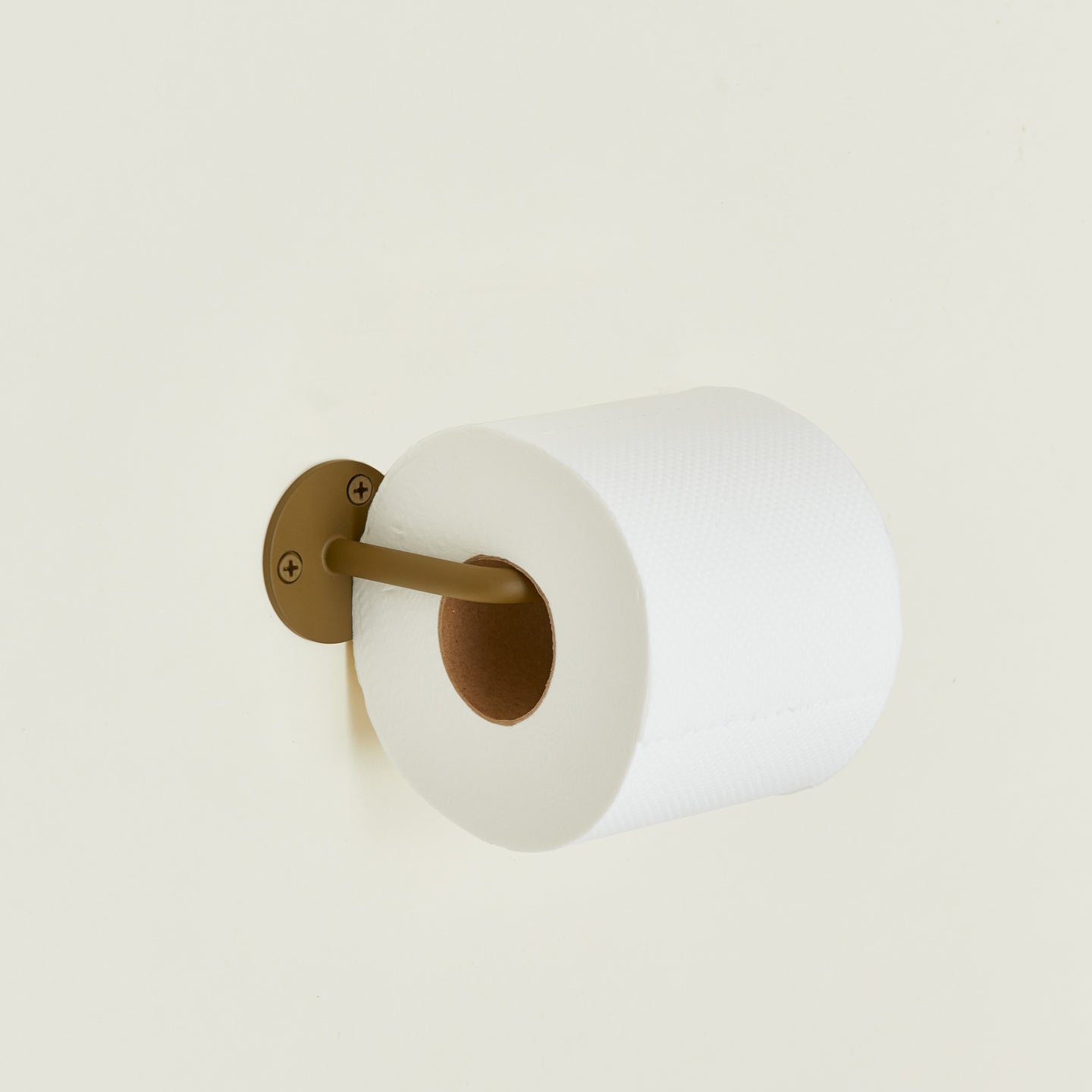 Toilet paper holder in Olive with a roll of toilet paper.