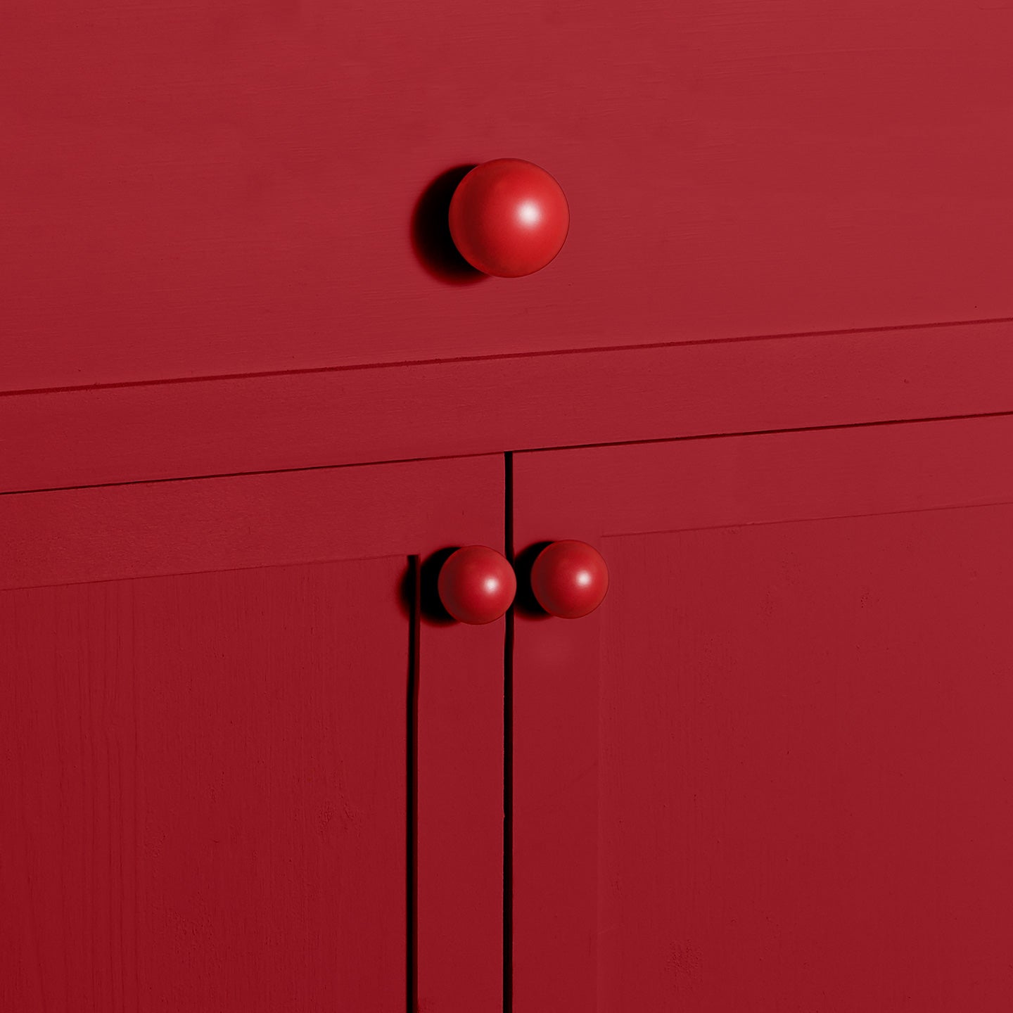 Sphere knobs in red in large and small on cabinets and drawer