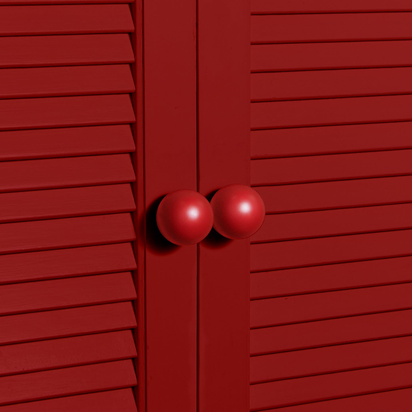 Large sphere knobs in red on cabinet