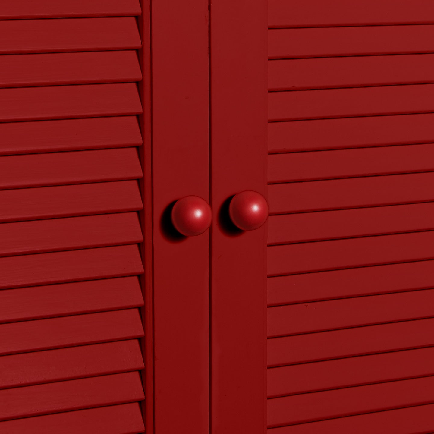 Small sphere knobs in red on cabinet
