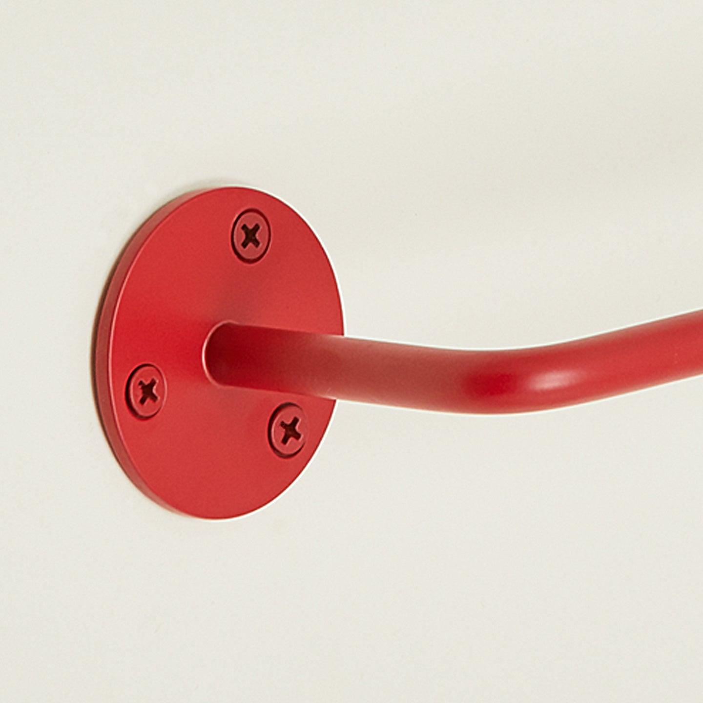 Close up view of essential toilet paper holder in red