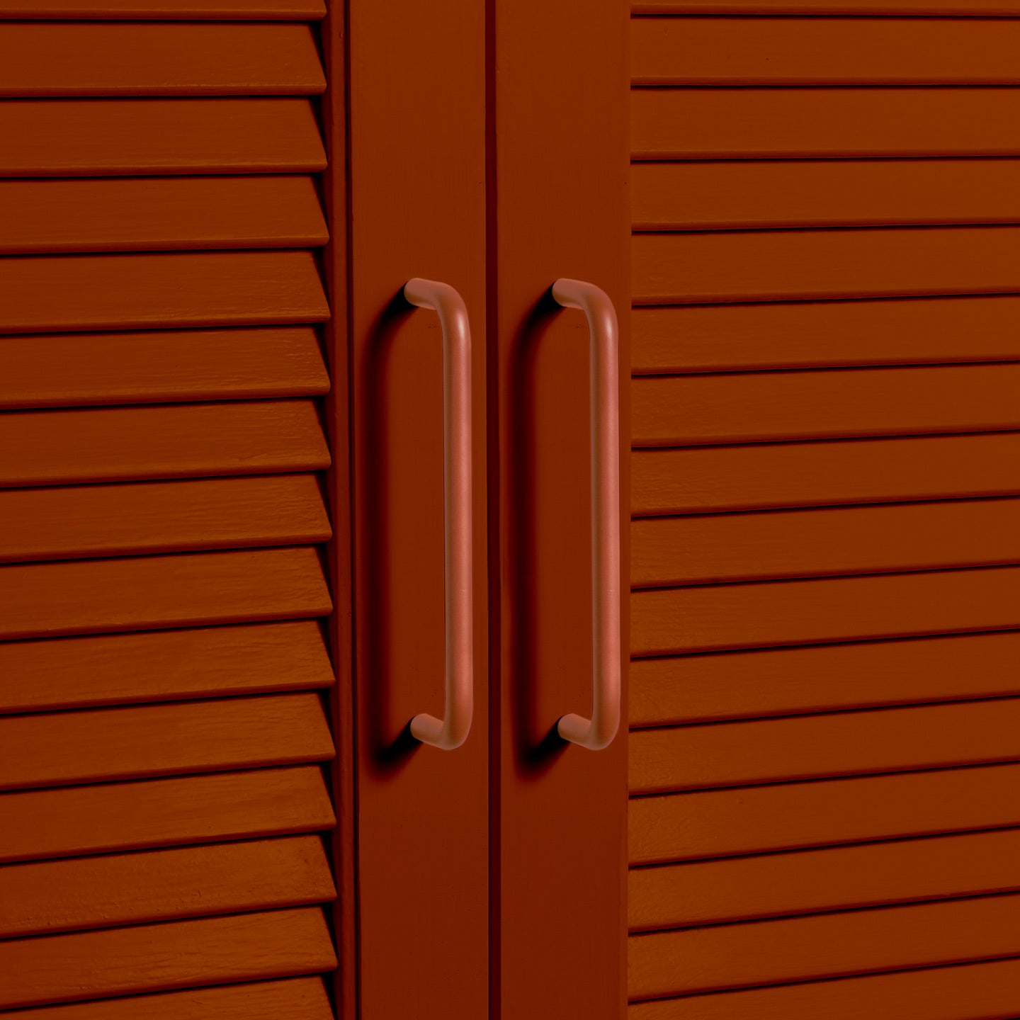 Large terracotta pulls on louvered doors