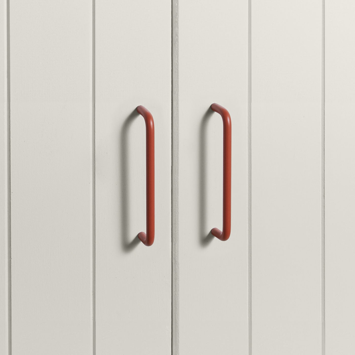 Large terracotta pulls on white doors