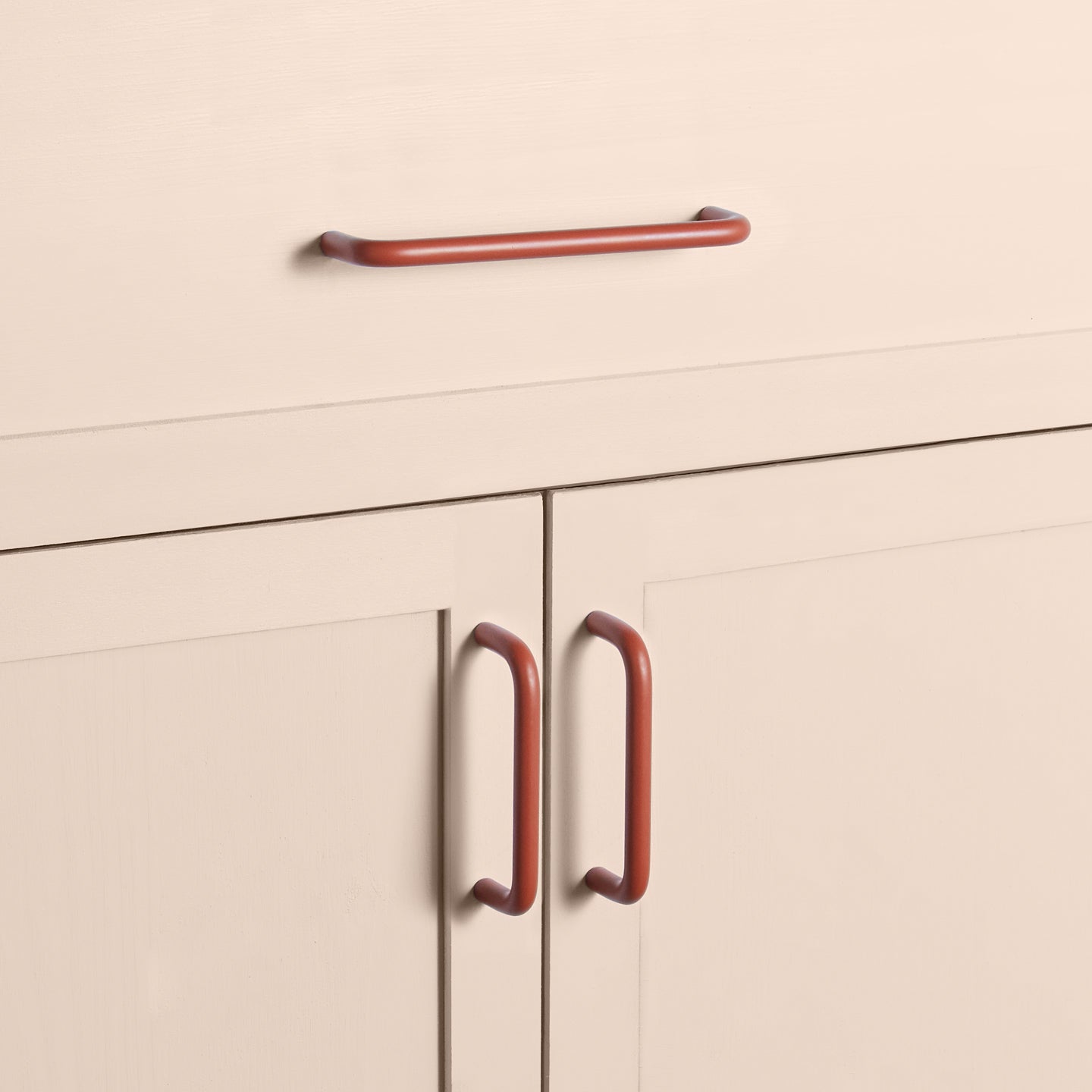 Large and small terracotta pulls on drawers and cabinets