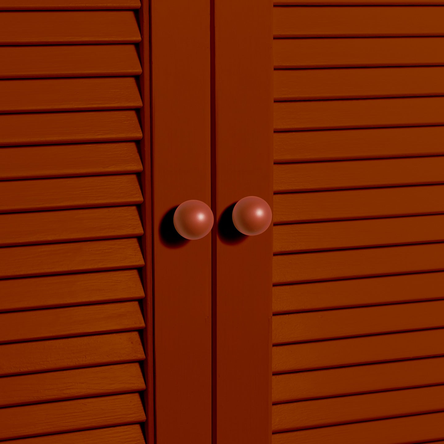Small terracotta essential sphere knobs on louvered doors