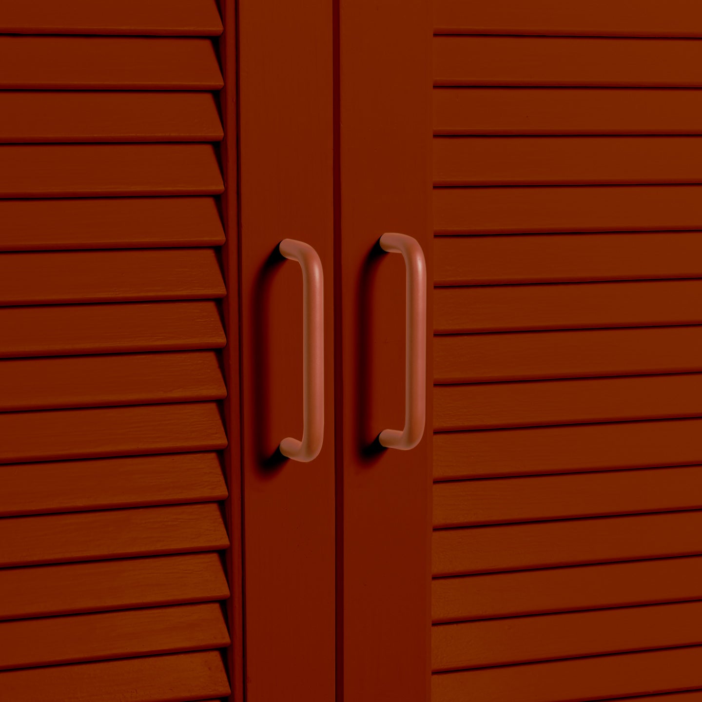 Small terracotta pulls on louvered doors