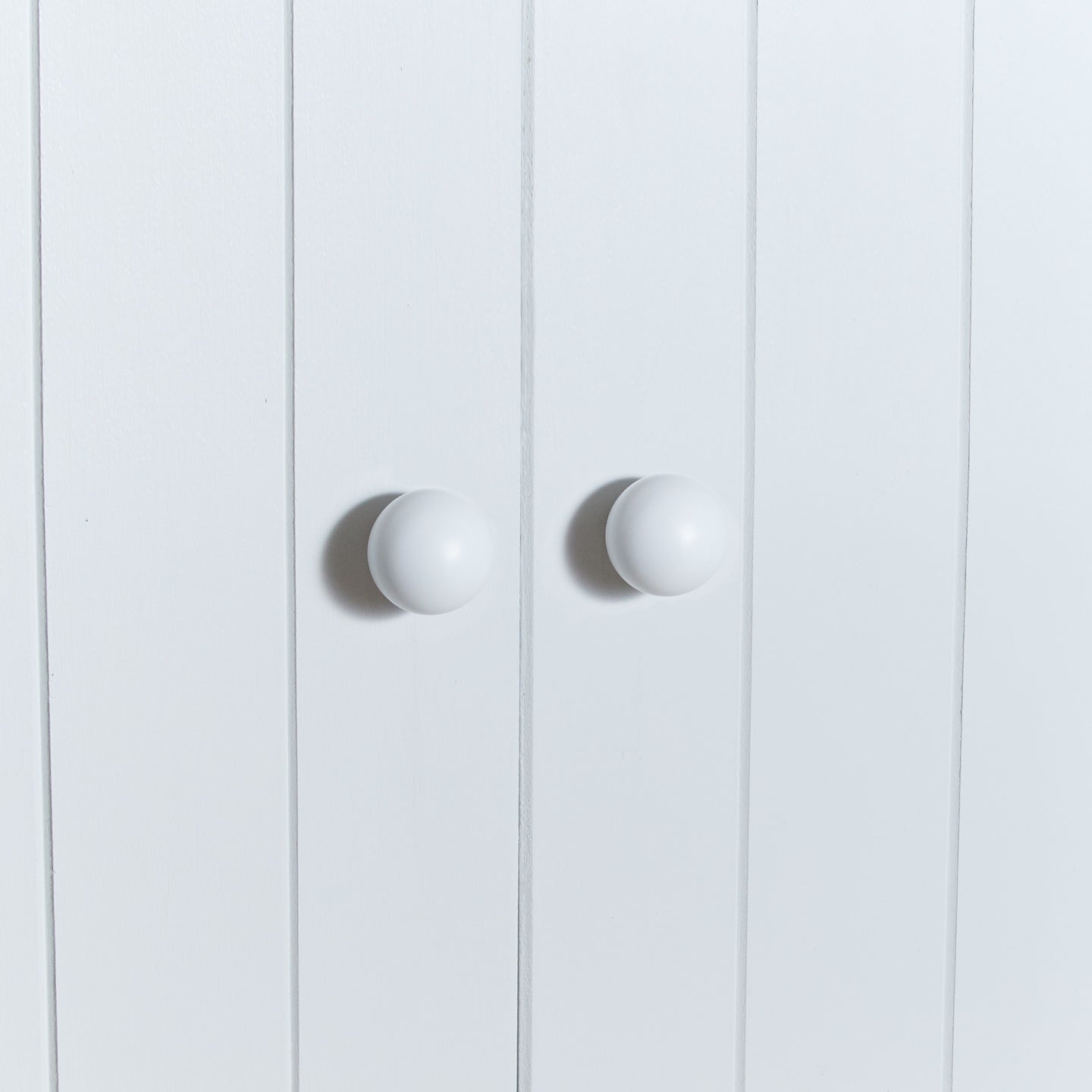 Large essential knobs in white on cabinet doors