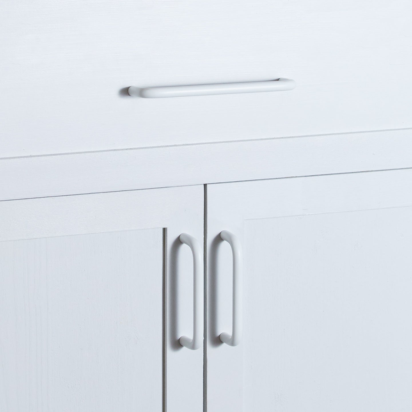 Large and small essential drawer pulls in white on cabinet and drawer