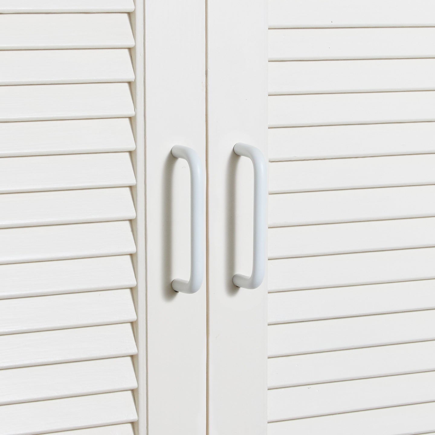 Small essential drawer pull in white on cabinets