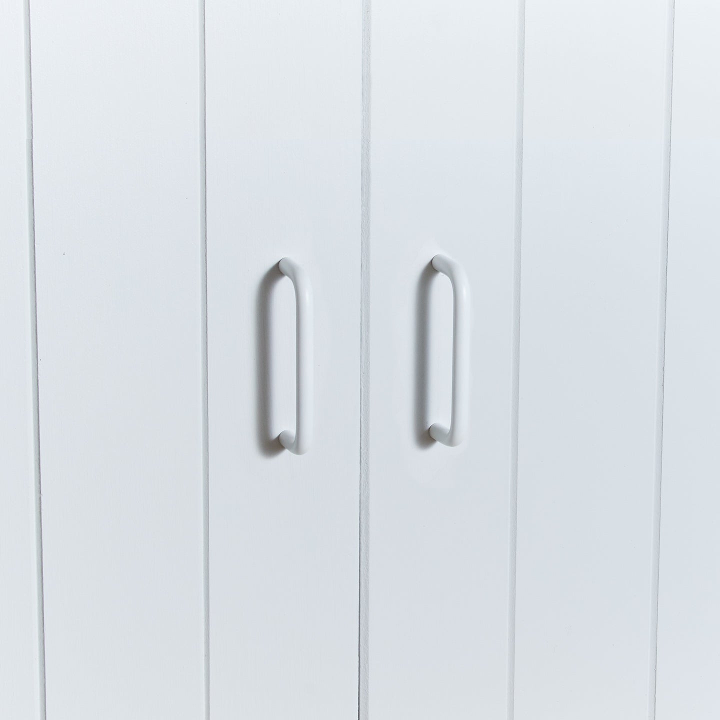 Small essential drawer pull in white on cabinet