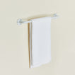Essential towel bar in white with towel.