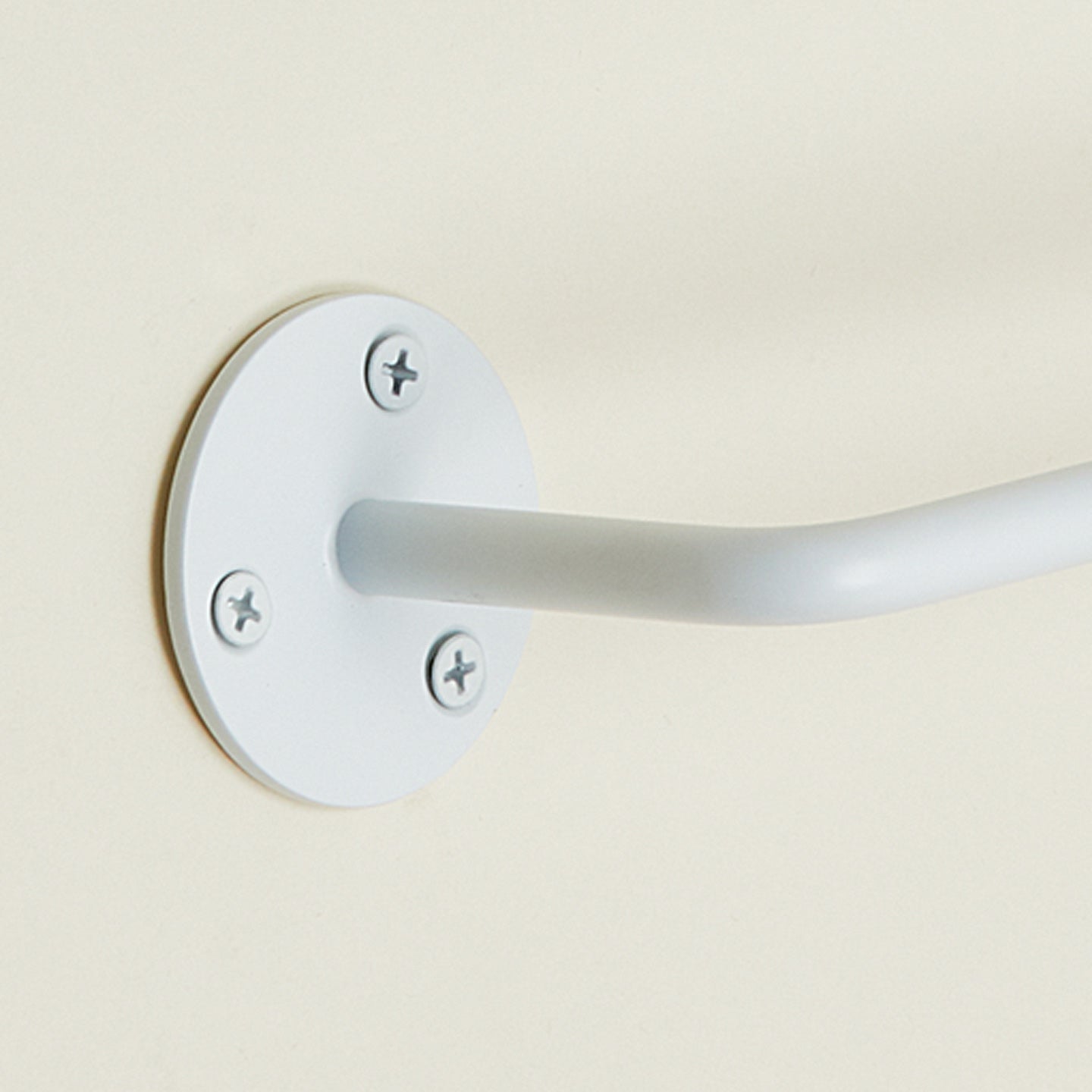 Close up view of essential toilet paper holder in white.