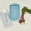 9x13 bakeware in sky with radishes, dishtowel, and spatula
