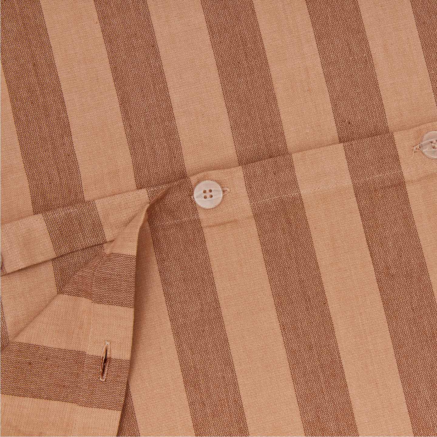 Close up view of essential striped duvet in blush/terracotta