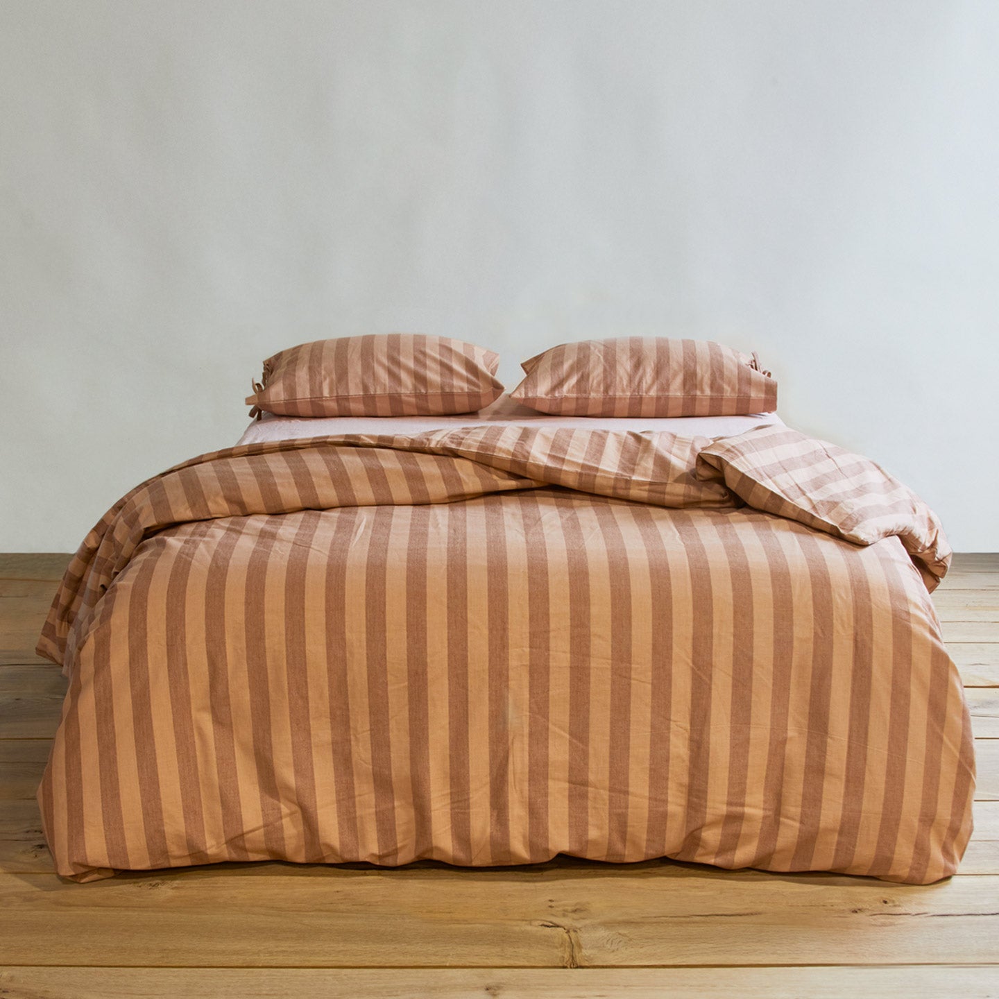 Essential Stripe Duvet - Blush/Terracotta on bed with matching pillow cases