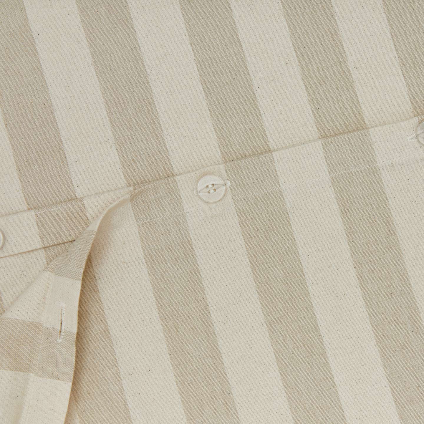 Close up view of essential striped duvet in ivory/flax