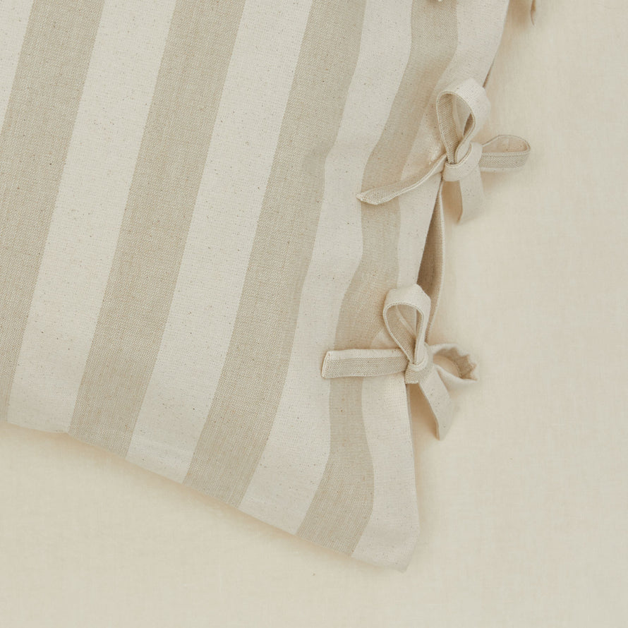 Close up view of striped pillow case in ivory/flax