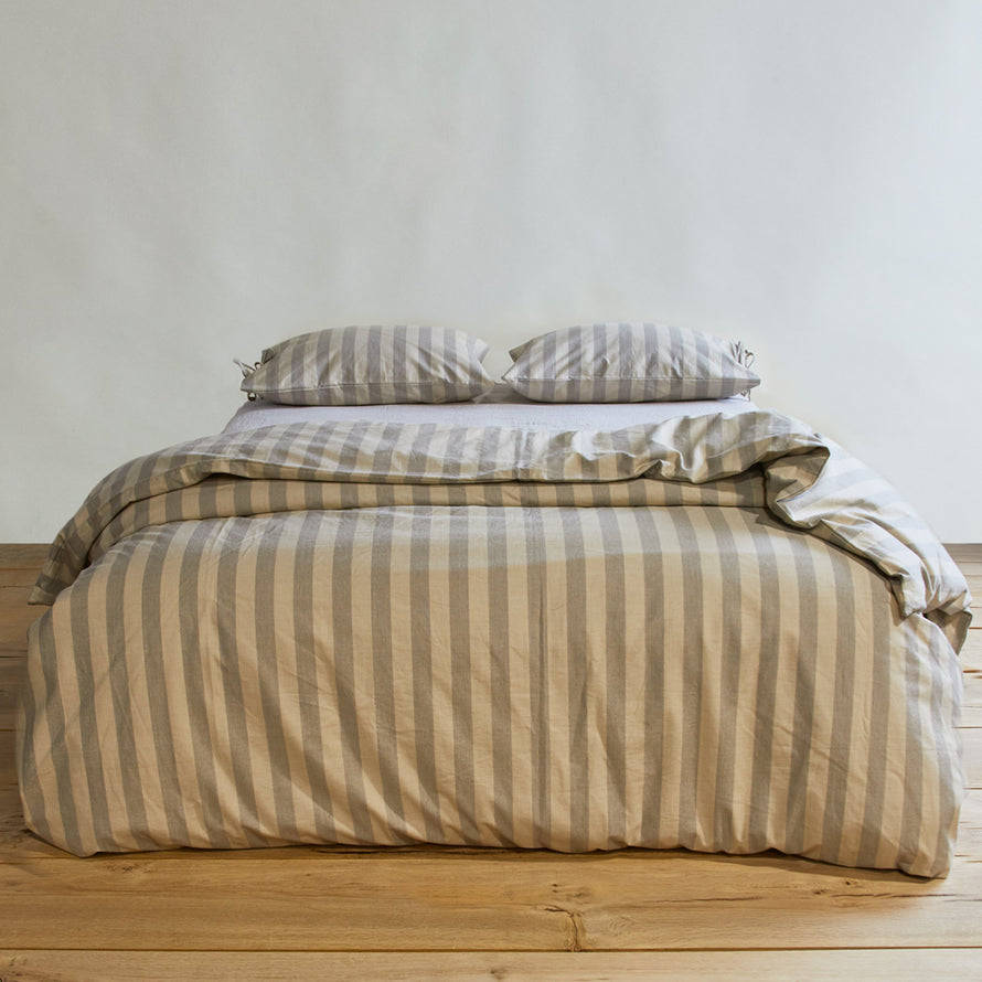 Essential Stripe Pillowcases, Set of 2 - Light Grey/Dark Grey on bed with matching duvet.