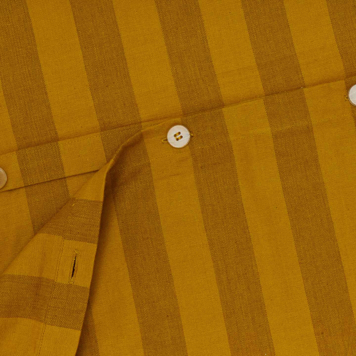 Close up view of essential striped duvet in mustard/bronze