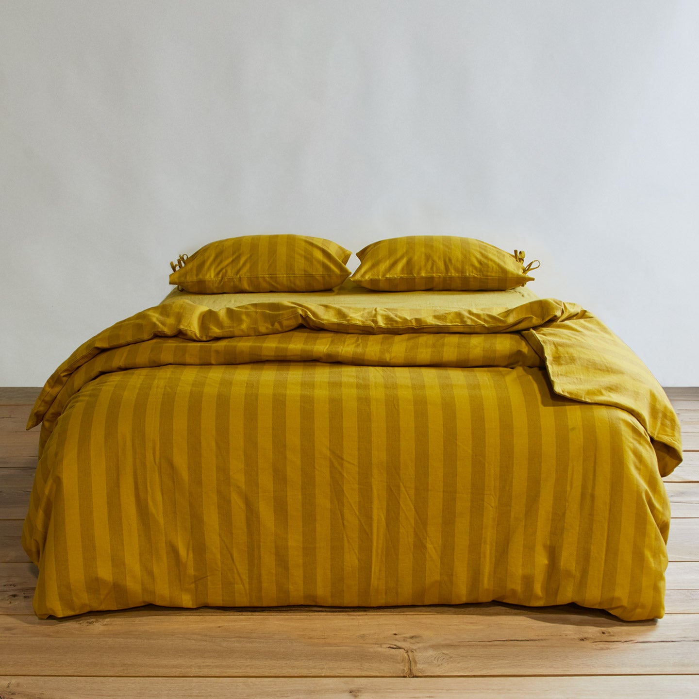 Essential Stripe Duvet - Mustard/Bronze on bed with matching pillow cases