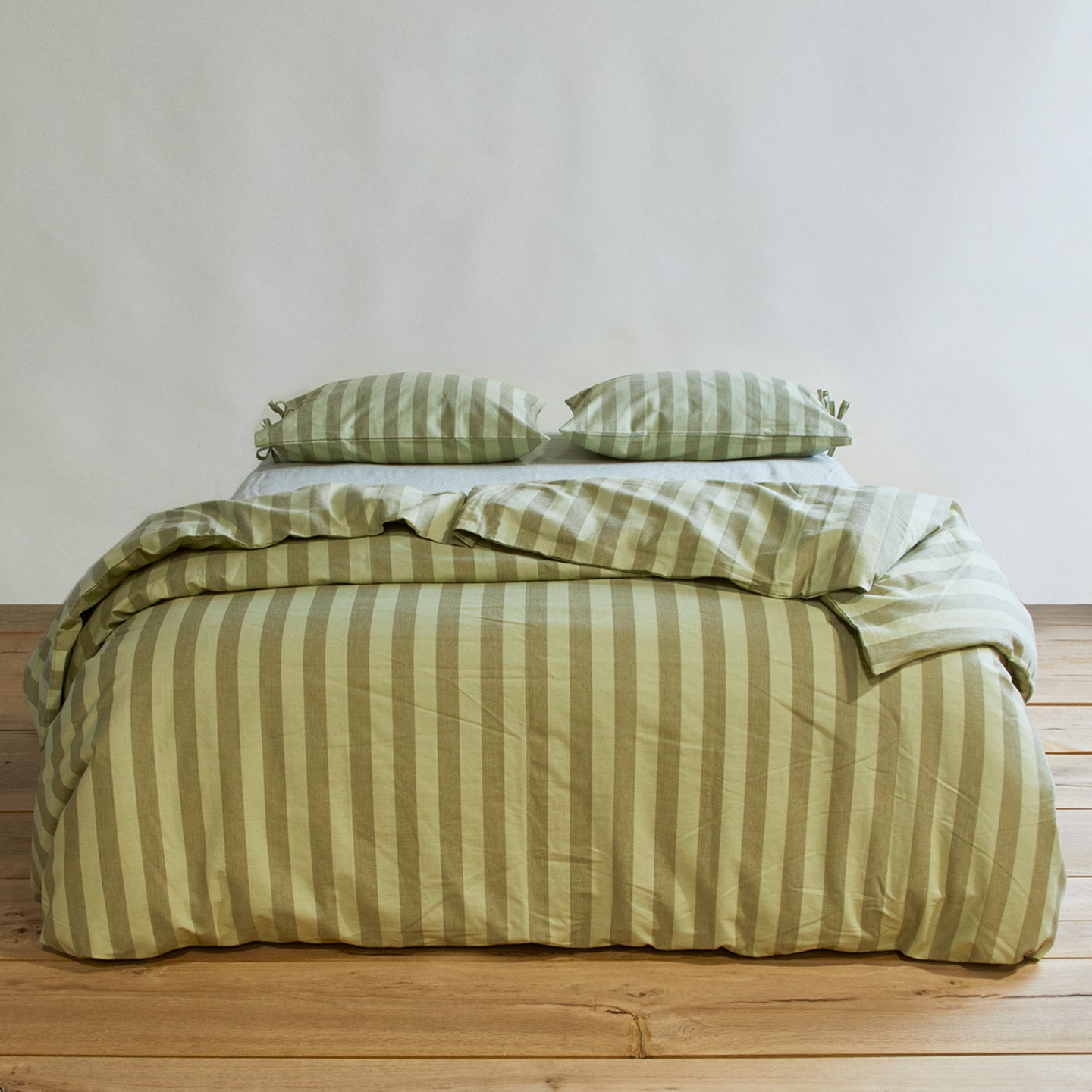 Essential Stripe Duvet - Sage/Olive on bed with matching pillow cases