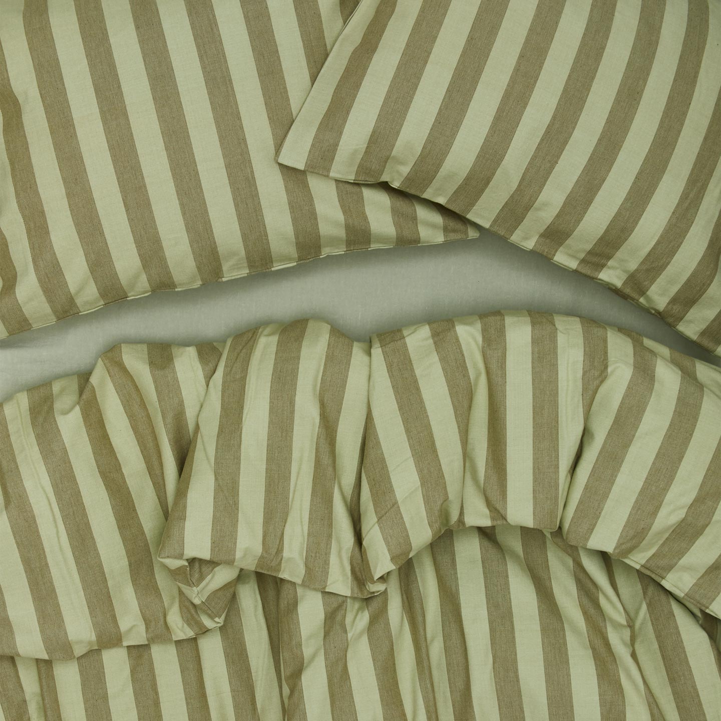 Essential Stripe Duvet - Sage/Olive on bed with matching pillow cases
