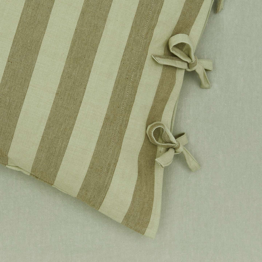 Close up view of olive/sage striped pillow case