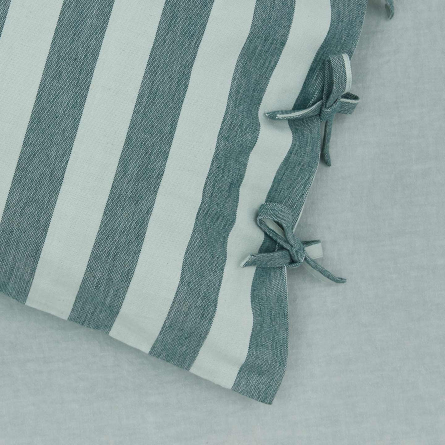 Close up view of essential striped pillowcase in sky/peacock