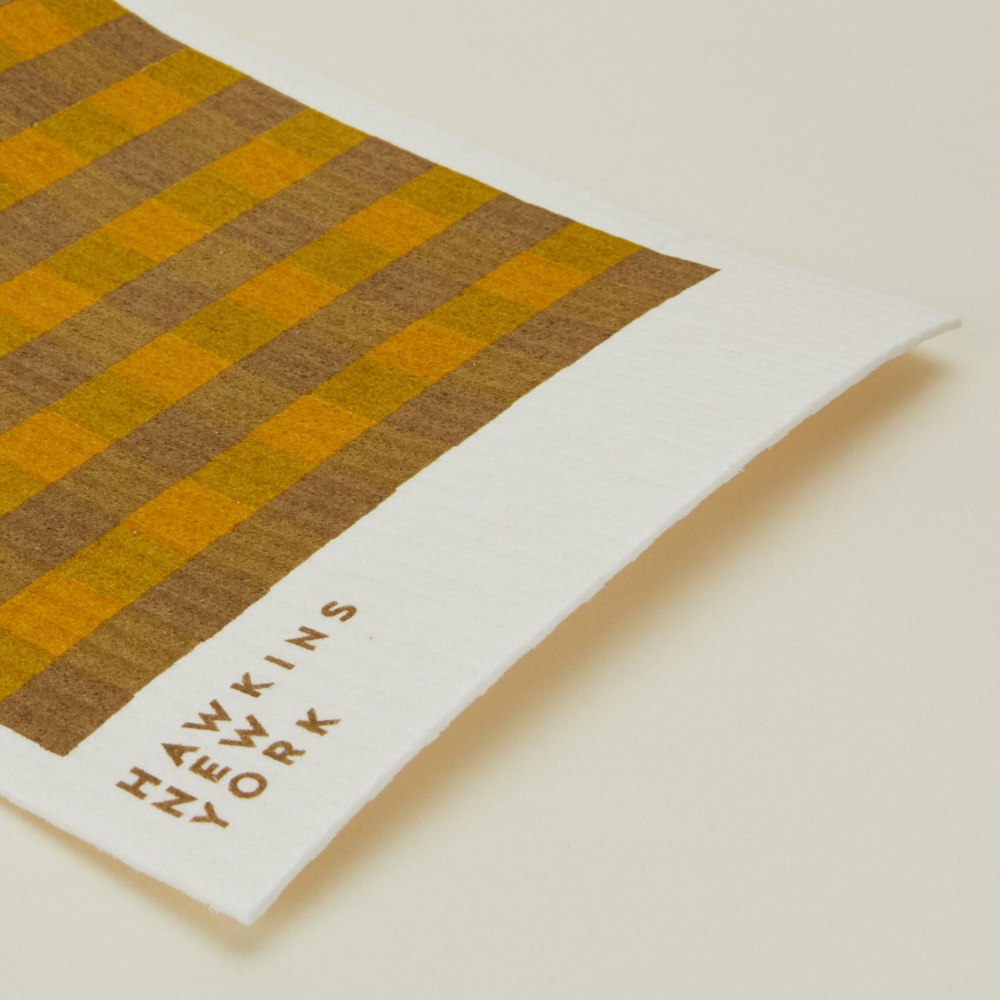 Close up view of essential swedish dishcloths in mustard/bronze